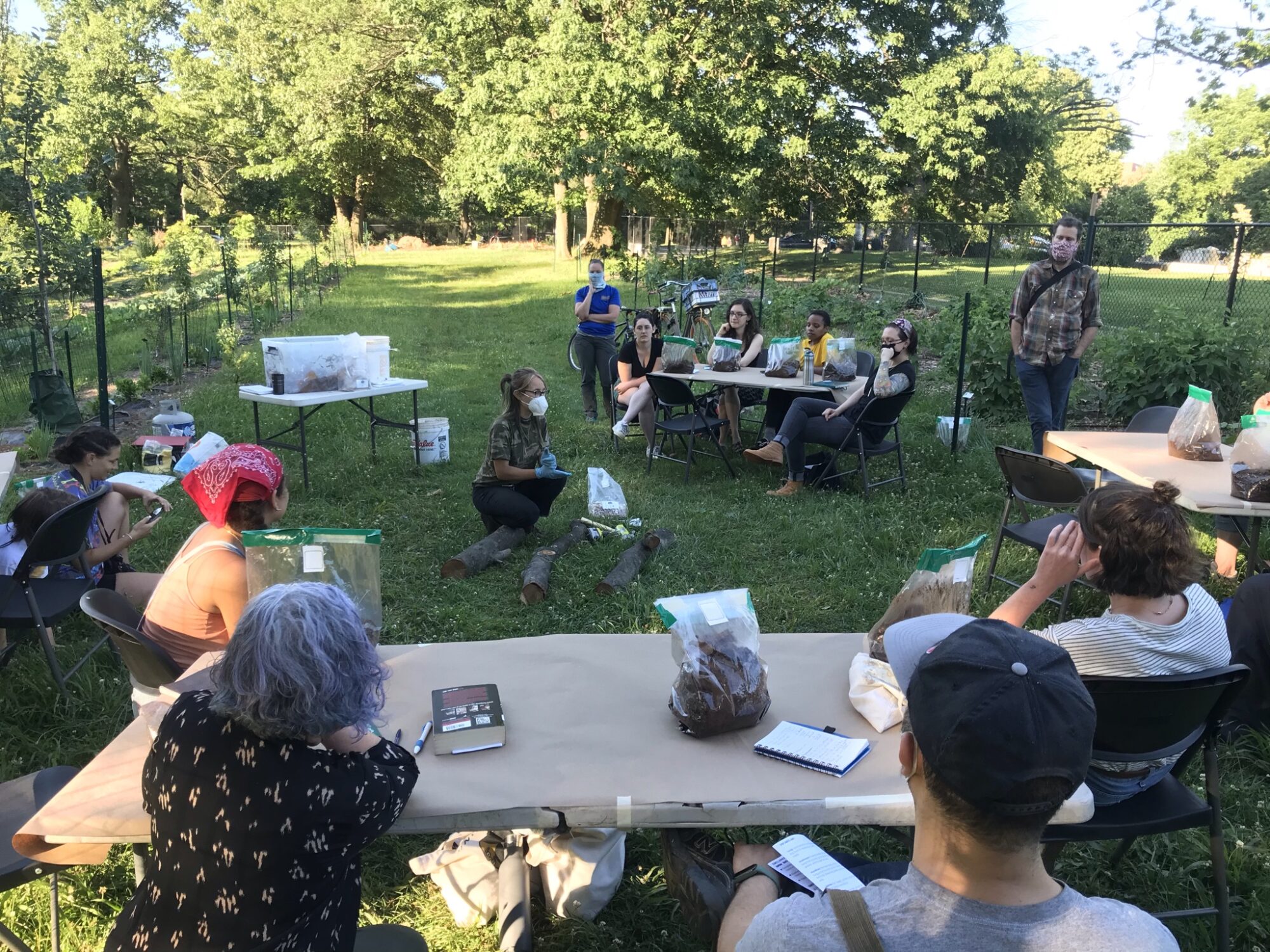People gathered at the learning orchard for a workshop